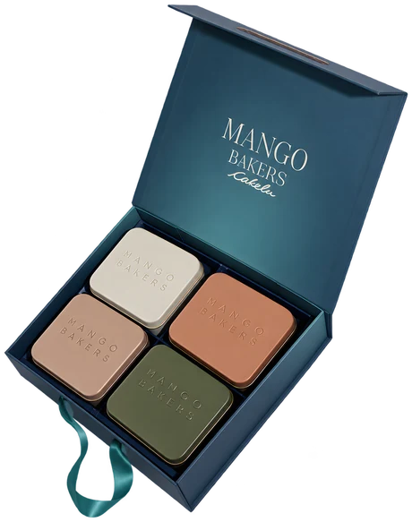 Open teal Mango Bakers Cakelu gift box with four embossed tins in ivory, rose, terracotta and olive